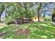 Expansive backyard with a chicken coop, yellow shed, and plenty of room for outdoor activities at 1110 Mercer Loop, Plant City, FL 33567
