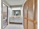 Bright bathroom featuring double sinks, a large mirror, wood-slatted closet doors, and toilet at 1110 Mercer Loop, Plant City, FL 33567