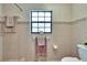 Neutral bathroom features a window, toilet, and decorative wall border at 1110 Mercer Loop, Plant City, FL 33567