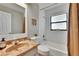 Bright bathroom features a marble sink, a combined shower and bathtub, and a window at 1110 Mercer Loop, Plant City, FL 33567