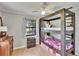 This bedroom has custom bunkbeds, natural light, wood floors, and a neutral color palette at 1110 Mercer Loop, Plant City, FL 33567