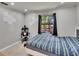 Bedroom featuring a platform bed, a gaming setup, and a large window for natural light at 1110 Mercer Loop, Plant City, FL 33567