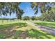 Large, grassy front yard showcasing mature trees and a winding driveway leading to the home at 1110 Mercer Loop, Plant City, FL 33567