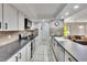 Updated kitchen features stainless appliances, white cabinetry, and an eat-in kitchen nearby at 1110 Mercer Loop, Plant City, FL 33567