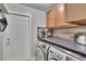 Efficient laundry room with modern washer and dryer, complemented by ample counter space and storage at 1110 Mercer Loop, Plant City, FL 33567