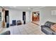 Spacious living room with an open floor plan, tiled flooring, and a seamless view to the dining area at 1110 Mercer Loop, Plant City, FL 33567