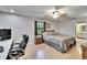 Spacious bedroom with a king bed, office desk, and an ensuite bathroom at 1110 Mercer Loop, Plant City, FL 33567