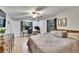 Bright bedroom featuring a king bed, wood furnishings, and natural light from two windows at 1110 Mercer Loop, Plant City, FL 33567