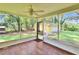 Screened patio with wood-look tile floors overlooking the backyard and detached garage at 1110 Mercer Loop, Plant City, FL 33567
