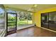 Bright screened porch with wood-look tile and access to the lush backyard at 1110 Mercer Loop, Plant City, FL 33567