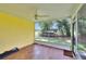 View of the screened porch with wood look tile flooring and a ceiling fan at 1110 Mercer Loop, Plant City, FL 33567