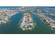 Dramatic aerial view showing a coastal home with direct access to a canal and expansive waterway at 11225 4Th E St, Treasure Island, FL 33706