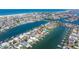 Scenic aerial capture of a waterfront home featuring a private dock, landscaping, and canal access at 11225 4Th E St, Treasure Island, FL 33706