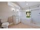 Updated bathroom boasts a glass-enclosed shower, custom vanity, soaking tub, and plenty of natural light at 11225 4Th E St, Treasure Island, FL 33706