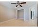 Bedroom with ceiling fan and closet and view into the kitchen at 11225 4Th E St, Treasure Island, FL 33706