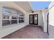 Close up of the home's brick paved entryway, double-door entrance, and an arched window at 11225 4Th E St, Treasure Island, FL 33706