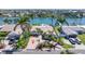 Charming waterfront home with a brick driveway and lush tropical landscaping at 11225 4Th E St, Treasure Island, FL 33706