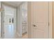 Hallway view of an updated bathroom featuring custom cabinetry and a granite countertop at 11225 4Th E St, Treasure Island, FL 33706