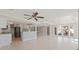 Open concept living area with tile floors, ceiling fan, and adjacent kitchen area for easy entertaining at 11225 4Th E St, Treasure Island, FL 33706