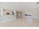 Open living area with tile flooring, and an arched window letting in natural sunlight at 11225 4Th E St, Treasure Island, FL 33706