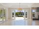 Bright living room with tile floors, high ceilings, and glass doors leading to an outdoor area at 11225 4Th E St, Treasure Island, FL 33706