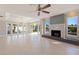 Bright living room with tile floors, fireplace, and a wall of windows to let in natural light at 11225 4Th E St, Treasure Island, FL 33706