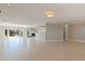 Open floor plan with a glimpse of the water, fireplace, and wet bar at 11225 4Th E St, Treasure Island, FL 33706