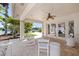 Covered outdoor patio with ceiling fan, seating, and views of the canal at 11225 4Th E St, Treasure Island, FL 33706