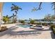 Inviting backyard pool and spa with lush landscaping and waterfront views at 11225 4Th E St, Treasure Island, FL 33706