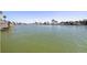 Expansive waterfront views showcasing the wide canal, lush greenery, and nearby docks at 11225 4Th E St, Treasure Island, FL 33706