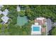 Aerial view of community pool, tennis courts, and complex amidst lush trees at 11941 Skylake Pl # 11941, Temple Terrace, FL 33617