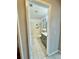 En suite bathroom with tiled floor and shower with storage shelving at 11941 Skylake Pl # 11941, Temple Terrace, FL 33617