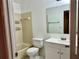 Bathroom featuring vanity sink, mirror, tile flooring, and tiled tub and shower at 11941 Skylake Pl # 11941, Temple Terrace, FL 33617