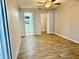 Bedroom featuring wood-look tile flooring, neutral walls, and natural light at 11941 Skylake Pl # 11941, Temple Terrace, FL 33617