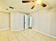 Bedroom featuring tile floors, ceiling fan, neutral paint, and a doorway leading to another room at 11941 Skylake Pl # 11941, Temple Terrace, FL 33617