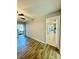 Bedroom with wood-look floors, ceiling fan, a sliding door, and a doorway to another space at 11941 Skylake Pl # 11941, Temple Terrace, FL 33617