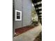 Exterior detail of gray siding with a white framed window and manicured mulch bed at 11941 Skylake Pl # 11941, Temple Terrace, FL 33617