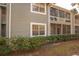 Exterior view of condo featuring screened in patios and well maintained landscaping at 11941 Skylake Pl # 11941, Temple Terrace, FL 33617