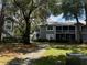 Exterior view of the well-maintained building featuring a screened lanai and stairs to the upper level at 11941 Skylake Pl # 11941, Temple Terrace, FL 33617