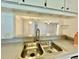 Kitchen sink area with view through to a bright and spacious living area at 11941 Skylake Pl # 11941, Temple Terrace, FL 33617