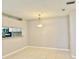 Bright living room with tile floors, a view into the kitchen and neutral paint at 11941 Skylake Pl # 11941, Temple Terrace, FL 33617