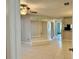 Bright living room with tile floors, mirror accent wall, and doorways leading to other areas at 11941 Skylake Pl # 11941, Temple Terrace, FL 33617