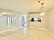 Open-concept living room with tiled flooring and views into the kitchen area at 11941 Skylake Pl # 11941, Temple Terrace, FL 33617