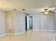 Spacious room with tile floors, neutral paint, ceiling fan, and multiple doorways at 11941 Skylake Pl # 11941, Temple Terrace, FL 33617