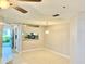 Bright living room with tile floors, ceiling fan, and an open view to the kitchen area at 11941 Skylake Pl # 11941, Temple Terrace, FL 33617