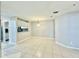 Spacious living room featuring neutral paint, tiled floors, and an open layout at 11941 Skylake Pl # 11941, Temple Terrace, FL 33617
