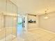 Bright living room with tile flooring, mirrors and views to the entryway at 11941 Skylake Pl # 11941, Temple Terrace, FL 33617