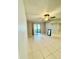 Bright living room featuring tile floors, ceiling fan, and access to a sliding glass door at 11941 Skylake Pl # 11941, Temple Terrace, FL 33617