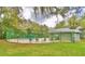 Community pool with lounge chairs, covered patio, and lush landscaping at 11941 Skylake Pl # 11941, Temple Terrace, FL 33617