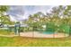 View of community pool surrounded by fence, with a covered patio at 11941 Skylake Pl # 11941, Temple Terrace, FL 33617